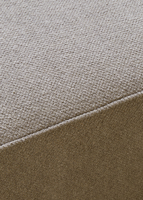 Close-up of the textured Audo Bouclé fabric in a light taupe colour, showing a seam detail on the Eave Modular Sofa Pouf.
