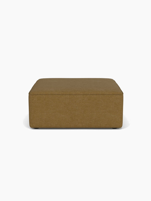 Front view of the Eave Modular Sofa, 96, Pouf, a square footstool upholstered in a brownish-gold Audo Bouclé 06 fabric.