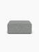 Front view of the Eave Modular Sofa, 96, Pouf, a square ottoman upholstered in textured, greyish-blue Safire 012 fabric.