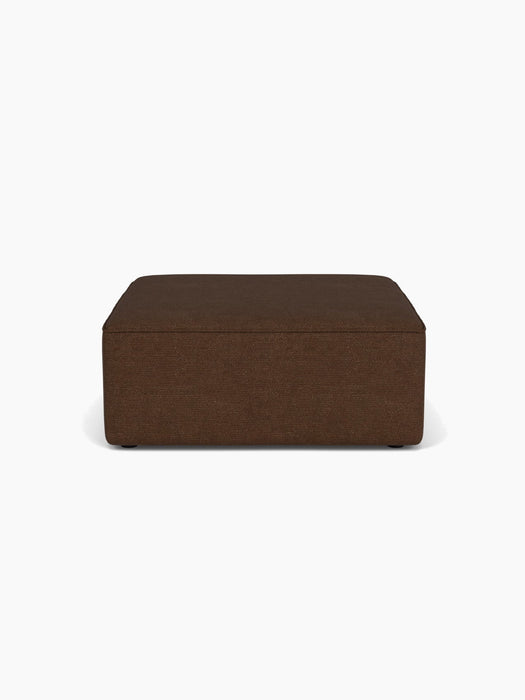 A front-on view of the rectangular Eave Modular Sofa, 96, Pouf, upholstered in a textured brown fabric.