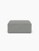 A front-on view of the rectangular Eave Modular Sofa Pouf, upholstered in a textured, grey-blue Safire fabric.