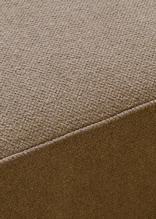 A close-up of the Eave Modular Sofa, highlighting the textured weave and diagonal seam of the brown Audo Bouclé fabric.