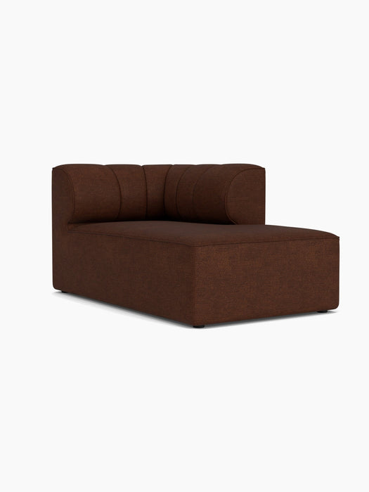 A studio shot of the Eave Seamline Modular Sofa, 86, Chaise Longue, upholstered in a textured, brown Audo Bouclé 08 fabric.