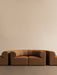 The Eave Seamline Modular Sofa, 86, Concave, Corner in a tan fabric, shown from the front against a simple, beige background.