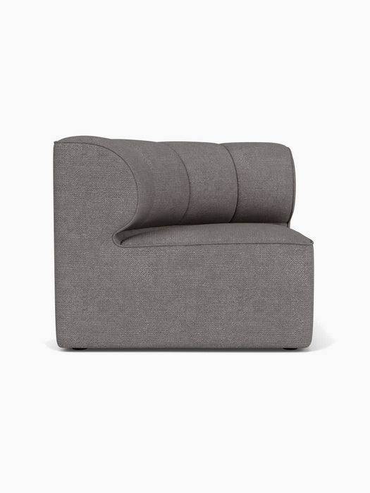 A left side view of the Eave Seamline Modular Sofa, Concave Corner module, upholstered in a textured grey bouclé fabric.
