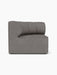 A left side view of the Eave Seamline Modular Sofa, Concave Corner module, upholstered in a textured grey bouclé fabric.
