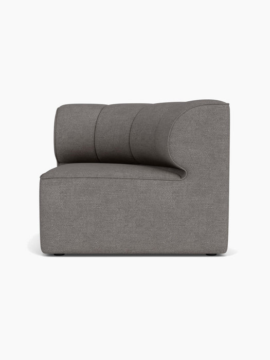 A side-on studio shot of the Eave Seamline Modular Sofa, 86, Concave, Corner, in a textured grey Audo Bouclé 16 fabric.
