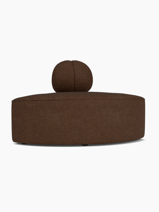 A front-on view of the Eave Seamline Modular Sofa, 86, Convex, Corner module in dark brown bouclé fabric.