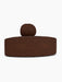 A front view of the Eave Seamline Modular Sofa convex corner module, upholstered in a dark brown Audo Bouclé 08 fabric.