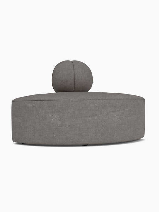 A side profile of the Eave Seamline Modular Sofa convex corner piece, upholstered in a textured grey Audo Bouclé fabric.