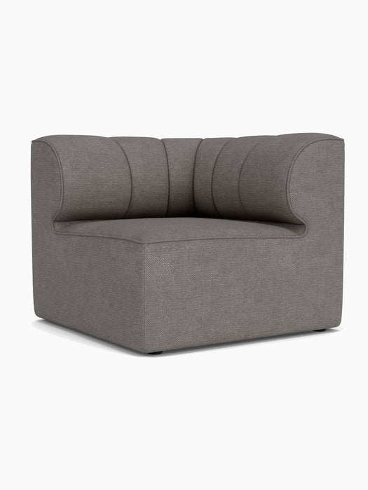 Eave Seamline Modular Sofa, 86, Corner module in a dark grey bouclé fabric, showing its distinct curved, channelled backrest.
