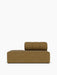 Frontal shot of a single brown fabric Eave Seamline Modular Sofa, 86, Open End module, with a deep seat and a low backrest.