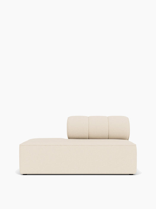 A front-on view of the Eave Seamline Modular Sofa's open-end module, upholstered in a light-coloured textured fabric.