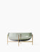 Front view of the Echasse Bowl, a wide, smoked green glass bowl on a slender, minimalist brass-coloured stand.