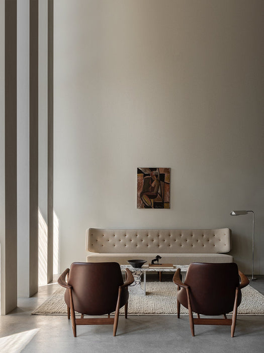 Rear view of two Elizabeth Lounge Chairs facing a Radiohus Sofa, Androgyne Table, and Wing Lamp in a modern living room.