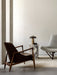 A living room featuring the brown leather Elizabeth Lounge Chair, a Plinth Tall marble table with a Reverse Table Lamp.