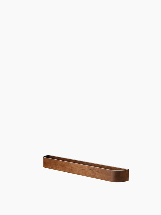 A minimalist wooden wall shelf, the Epoch Rack 79 in Natural Oak, featuring a long, slim design with softly rounded corners.