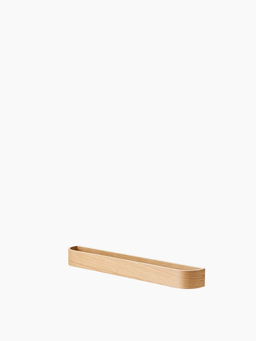 The Epoch Rack 79 in natural oak, a long and shallow wooden shelf with rounded ends, shown at an angle on a white background.