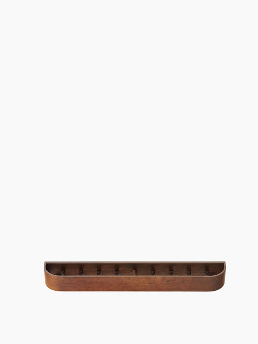 The Epoch Rack 79 in dark stained oak, a long wooden wall shelf with a raised edge and several hooks, viewed from the front.