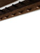 Close-up detail of a dark stained oak shelf with two rows of wooden pegs. The wood grain and peg reflections are visible.