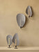 A group of four Flambeau Candle Holders, two mounted on a beige wall and two standing on a table against the same wall.