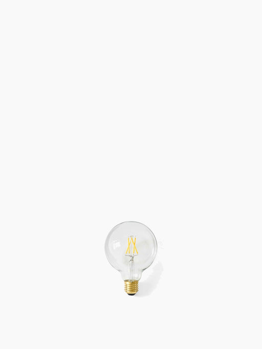 A clear, spherical Globe LED Bulb with a visible yellow filament and a brass-colored screw base on a white background.