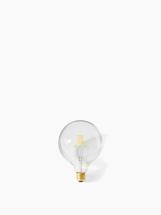 A Globe LED Bulb with clear glass and a brass base, shown against a white background. The yellow LED filament is visible.