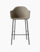 Front view of the Harbour Bar Chair, Upholstered, with a light brown fabric seat and slender black steel legs with footrest.