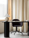 A purple Harbour Dining Chair at a black Eclipse Desk. A Torso Table Lamp sits on the desk by a window with sheer curtains.