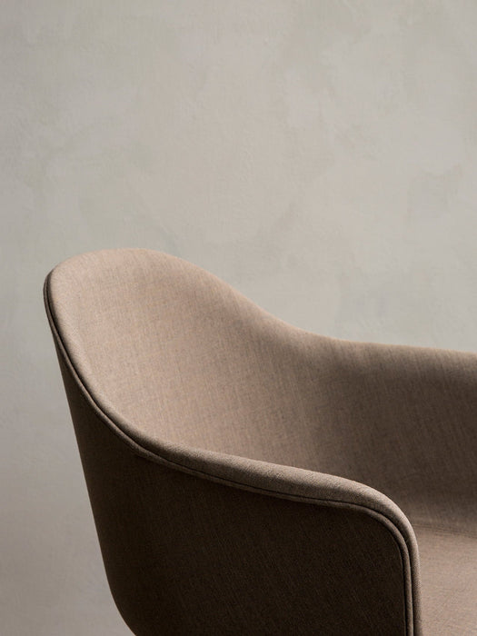 A close-up of the Harbour Dining Chair's upholstered back, showing the textured brown fabric and the soft, curved silhouette.