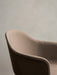A close-up of the Harbour Dining Chair's upholstered back, showing the textured brown fabric and the soft, curved silhouette.