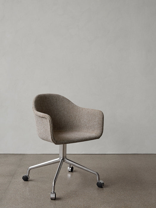 A Harbour Dining Chair upholstered in brown fabric, standing on a polished aluminium swivel star base with black casters.