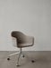 A Harbour Dining Chair upholstered in brown fabric, standing on a polished aluminium swivel star base with black casters.