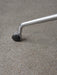 Close-up of a Harbour Dining Chair's polished aluminium star base with a black caster wheel on a grey floor.