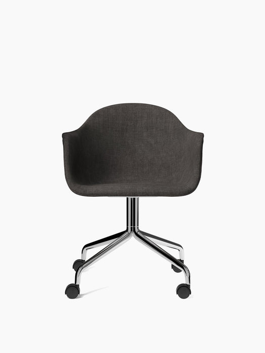 A front-facing Harbour Dining Chair upholstered in dark grey Canvas fabric, with a polished aluminium star base and casters.