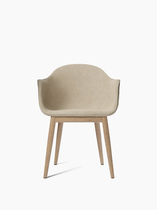 The Harbour Dining Chair, shown from the front, with off-white bouclé upholstery and a four-legged base in natural oak.