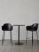 A black Harbour Column Bar Table with a rectangular top and round base, flanked by two black upholstered Harbour Bar Chairs.