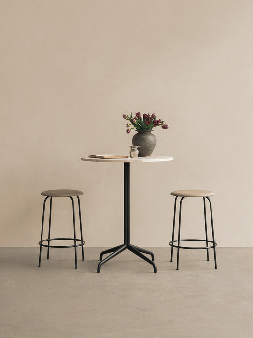 Harbour Column Counter Table with a white marble top and black star base, styled with two Afteroom Counter Stools and a vase.