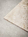 A detailed, top-down view of the Kunis Breccia marble corner of the Harbour Column Table, showcasing its rich, earthy tones.