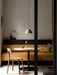 A Harbour Column Dining Table in a cosy dining nook, with a mustard banquette, wooden chair, and an olive green pendant lamp.