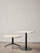 A Harbour Column Lounge Table with a round stone top and star base, next to a taller, square Harbour Column Dining Table.