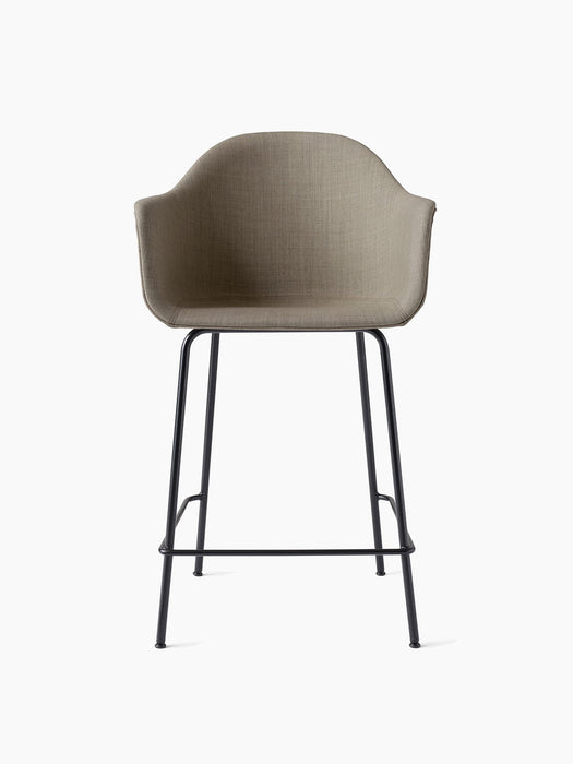 Front view of the Harbour Counter Chair, Upholstered. Features a light brown fabric shell on a slender, black metal frame.