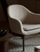 A close-up of the light, textured Harbour Lounge Chair on a Gravel Rug, next to an Androgyne Side Table with a Fragilis Bowl.