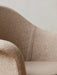 A close-up of the Harbour Lounge Chair, showing its textured beige and brown woven upholstery and curved backrest.