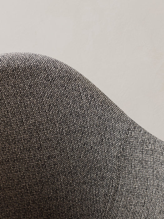Close-up of the Harbour Lounge Chair showing the textured black and cream woven fabric on the chair's curved backrest.