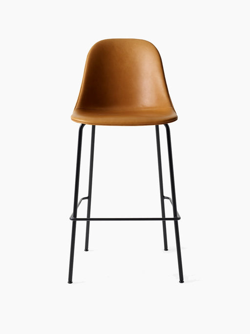 Front view of the Harbour Side Bar Chair, upholstered in tan Dakar leather, on a slender black steel base with a footrest.
