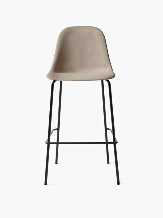 A front-on studio shot of the Harbour Side Bar Chair with a light beige upholstered seat and a slender black metal frame.