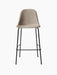 A front-on studio shot of the Harbour Side Bar Chair with a light beige upholstered seat and a slender black metal frame.