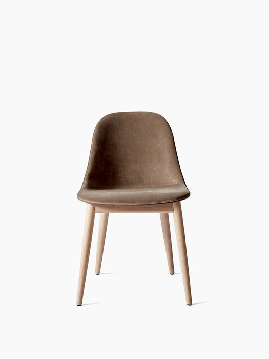 A front view of the Harbour Side Dining Chair, featuring a brown velvet upholstered shell on a natural oak wooden base.