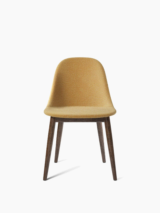 A Harbour Side Dining Chair with a wooden base, moss-green upholstered shell and dark stained oak legs.